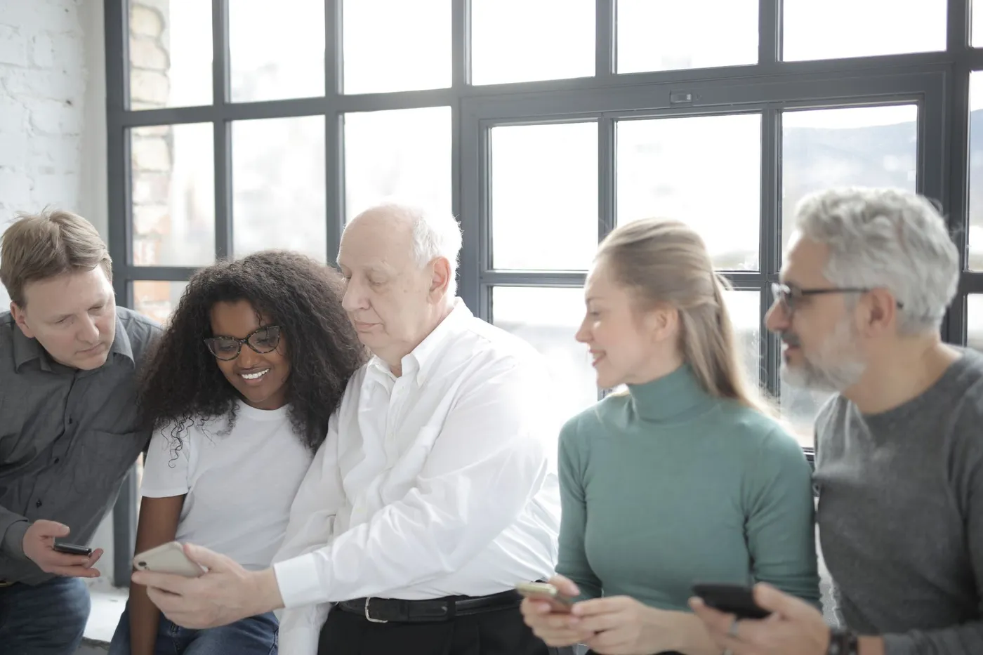 Une équipe échange autour d’un smartphone